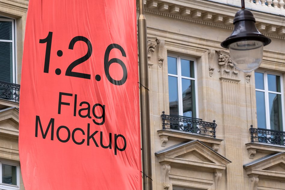 Red flag mockup hanging on classic building, urban setting, clear text space, realistic design presentation tool for graphic designers.